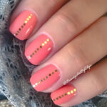 Coral Nails with Chunky Gold Glitter Line